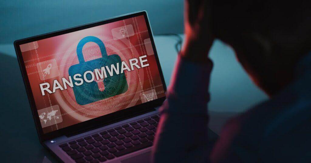 Ransomware loaded on a laptop with a frustrated employee.