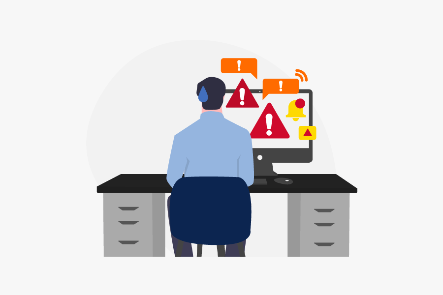 Malware icon of a man sitting at a computer desk.