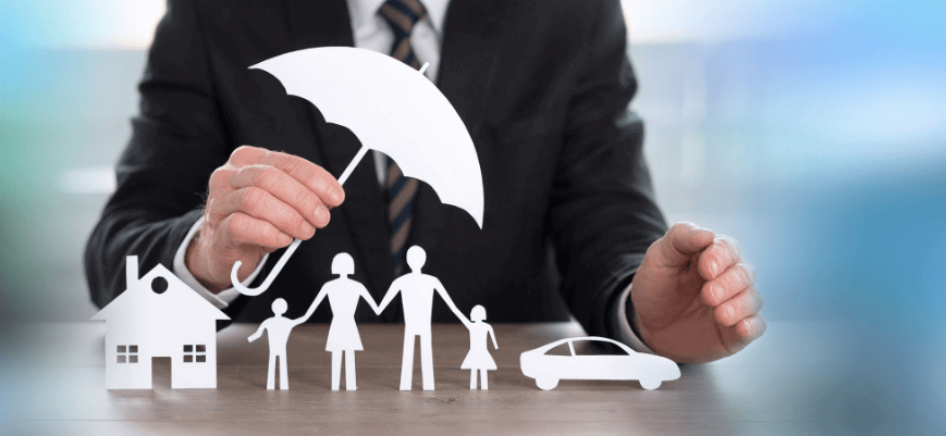 Businessman holding an umbrella insurance policy representation.