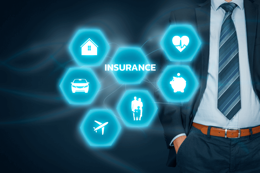 3D insurance icons in front of a businessman.