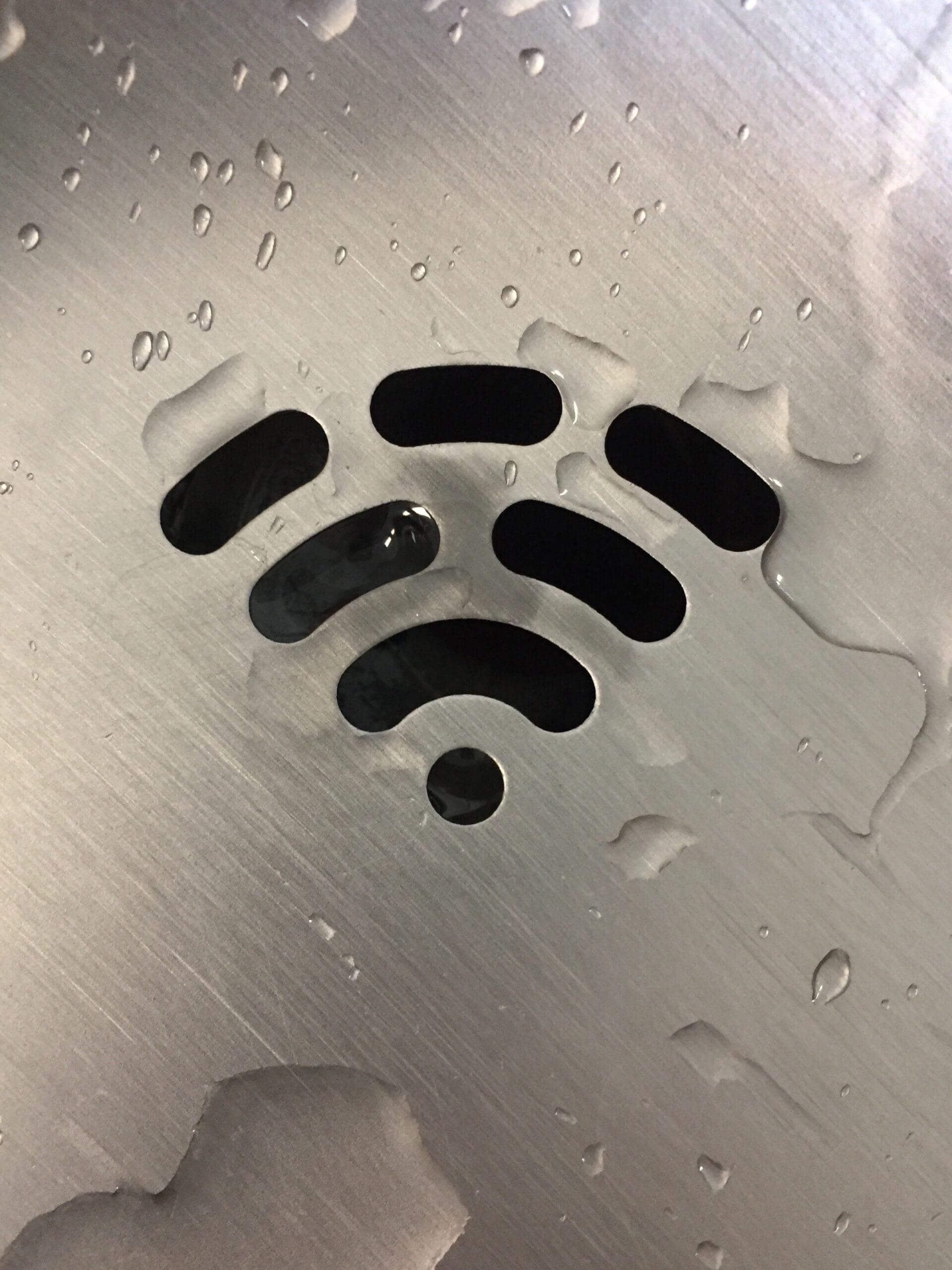 Drain in a sink shaped to look like a Wifi symbol.