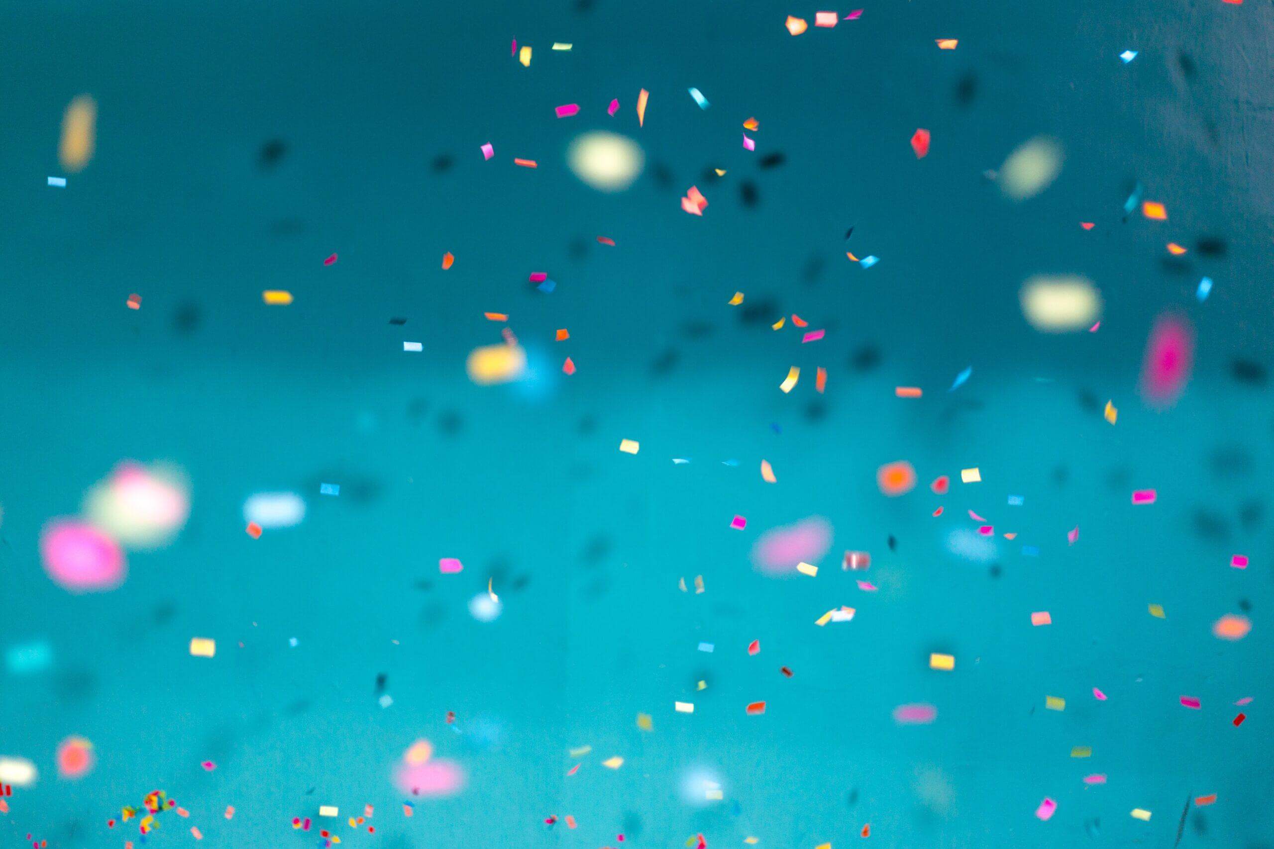 Confetti falling on a blue background.