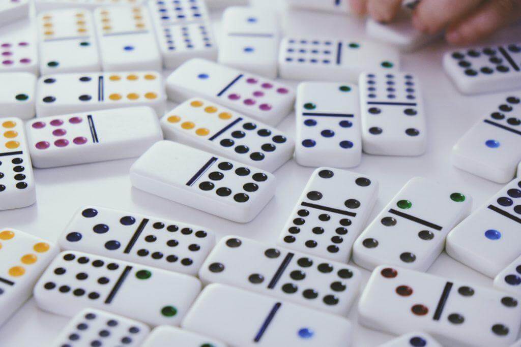 Dominoes laying on a white table.