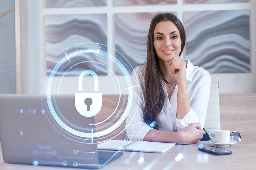 Woman at a desk with a digital lock icon.